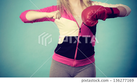 Woman holding boxing gloves Woman holding boxing gloves 136277169