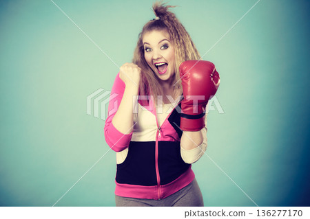 Funny girl in red gloves playing sports boxing Funny girl in red gloves playing sports boxing 136277170