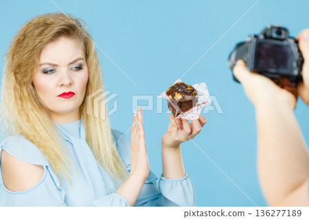 Woman refuses to eat chocolate cupcake Woman refuses to eat chocolate cupcake 136277189