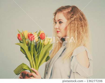 Pretty woman with red yellow tulips bunch Pretty woman with red yellow tulips bunch 136277206