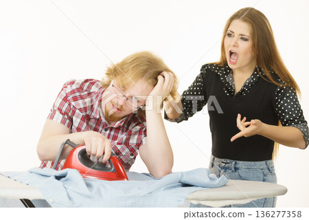 Couple arguing about ironing Couple arguing about ironing 136277358