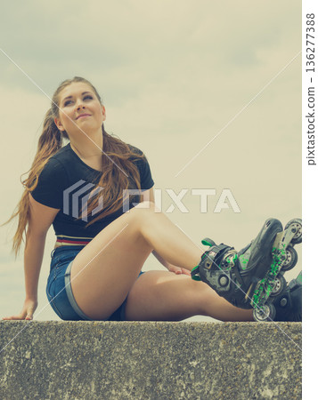 Fit girl with roller skates outdoor Fit girl with roller skates outdoor 136277388