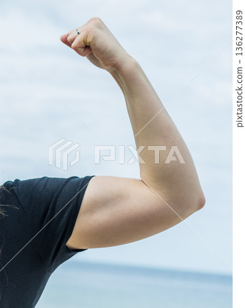 Woman showing arm muscle 136277389