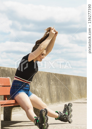Joyful girl wearing roller skates 136277390
