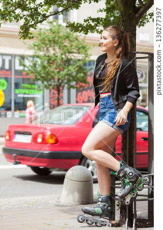 Young woman riding roller skates Young woman riding roller skates 136277397