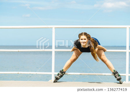 Girl wearing roller skates on seaside 136277419