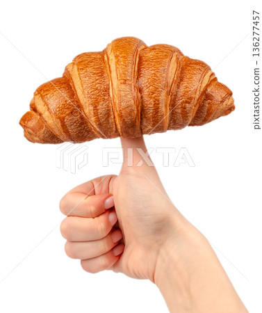 Fresh croissant balanced on finger isolated on white background 136277457