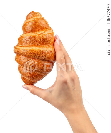 Croissant held between fingers isolated on white background Croissant held between fingers isolated on white background 136277470