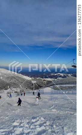 Skiers on snowy mountain slope Skiers on snowy mountain slope 136277755