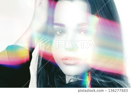 Woman with colorful rainbow light flare across face 136277883