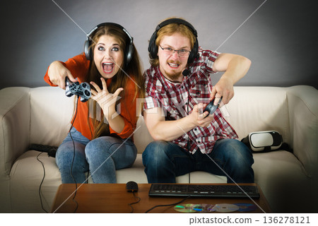 Gaming couple playing games Gaming couple playing games 136278121