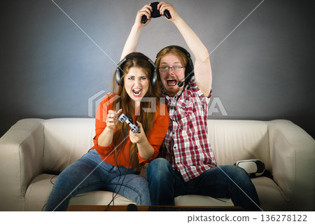 Gamer couple playing games Gamer couple playing games 136278122