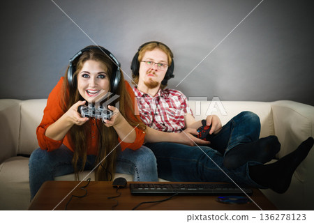 Gaming couple playing games Gaming couple playing games 136278123