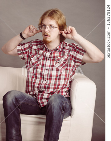 Man being annoyed with noise Man being annoyed with noise 136278124