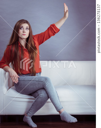 Angry woman sitting on sofa 136278137