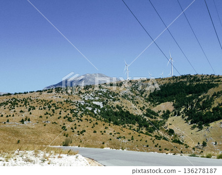 Wind turbines on rolling hills 136278187