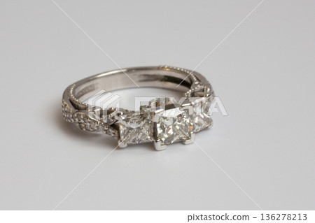 Engagement diamond wedding ring group on white. A white gold ring with large natural princess-cut or Square Modified Brilliant diamonds. 136278213