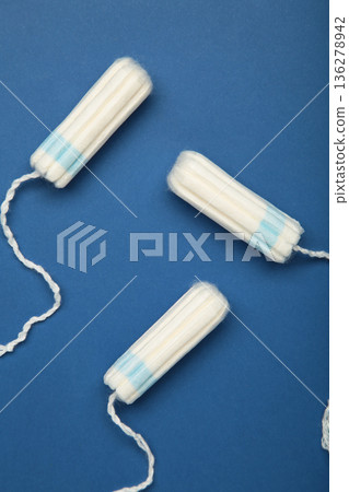 Cotton tampons for women hygiene menstrual period on blue background. Cotton tampons for women hygiene menstrual period on blue background. 136278942