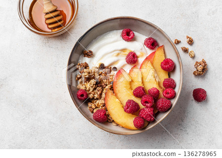 Granola bowl with greek yogurt, peach, raspberry and honey Granola bowl with greek yogurt, peach, raspberry and honey 136278965