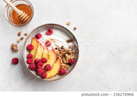 Granola bowl with greek yogurt, peach, raspberry and honey Granola bowl with greek yogurt, peach, raspberry and honey 136278966