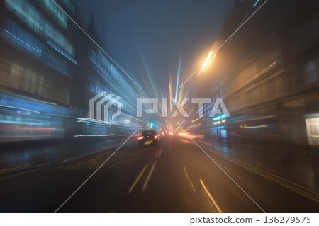 A blurry, fast-moving light, reminiscent of headlight trails on a city road, with a very long exposure and night lighting. The speed effect A blurry, fast-moving light, reminiscent of headlight trails on a city road, with a very long exposure and night lighting. The speed effect 136279575