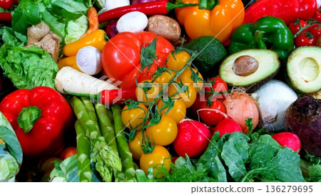 Fresh vegetables displayed on a market table during daytime in a busy outdoor setting Fresh vegetables displayed on a market table during daytime in a busy outdoor setting 136279695