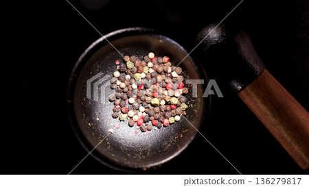 Peppercorns placed in a mortar ready for grinding in a kitchen setting during the day Peppercorns placed in a mortar ready for grinding in a kitchen setting during the day 136279817