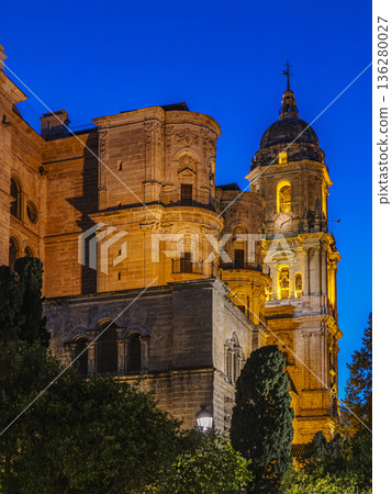 Golden Night Illumination of Historic Malaga Cathedral with Dome and Tower at Deep Blue Sky 136280027
