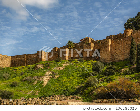 Ancient Ruins of Gibralfaro castle on a Green Hill Under a Clear Blue Sky 136280029