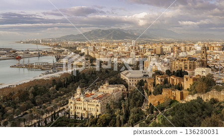 Coastal Cityscape Of Malaga With Historical buildings, Modern Waterfront And Mountain Backdrop At sunrise Coastal Cityscape Of Malaga With Historical buildings, Modern Waterfront And Mountain Backdrop At sunrise 136280031