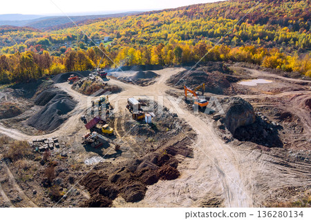 Heavy machinery is moving earth, rock at construction site for future development Heavy machinery is moving earth, rock at construction site for future development 136280134