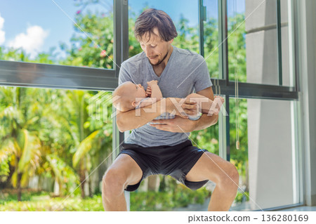 Father exercising with his small baby at home, active parenting and healthy lifestyle. Strong family bond, early physical development, modern fatherhood, fitness with children concept. Father exercising with his small baby at home, active parenting and healthy lifestyle. Strong family bond, early physical development, modern fatherhood, fitness with children concept. 136280169
