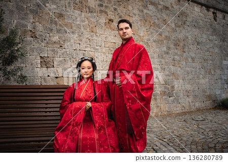 Diverse couple celebrating wedding in traditional Hanfu attire Diverse couple celebrating wedding in traditional Hanfu attire 136280789