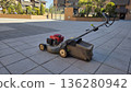 Efficient lawn care with modern lawnmower for urban landscape maintenance 136280942