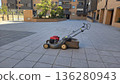 Lawn mower on pavement in urban residential area 136280943
