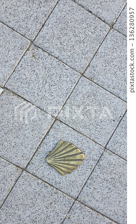 Camino de santiago journey symbolized by shell marker on pavement Camino de santiago journey symbolized by shell marker on pavement 136280957