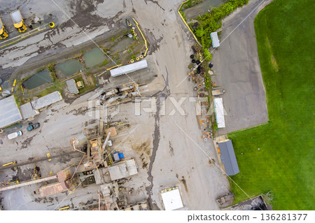 View of construction site with machinery vehicles surrounded by stone quarry water area View of construction site with machinery vehicles surrounded by stone quarry water area 136281377