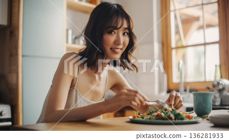 一位日本女性在廚房享用早餐，沐浴著清晨的陽光。生活方式 136281933