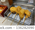 Four freshly fried skewers on a tray 136282090