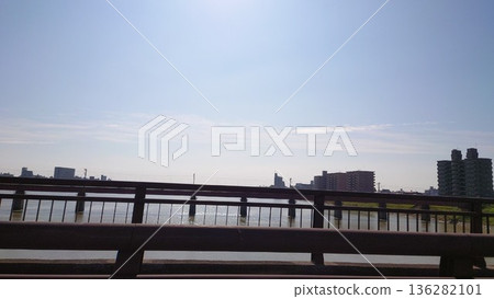 River and bridge on a sunny day, a calm everyday city scene 136282101