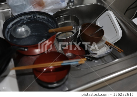 A kitchen sink filled with dishes gives off a sense of everyday life. A kitchen sink filled with dishes gives off a sense of everyday life. 136282615