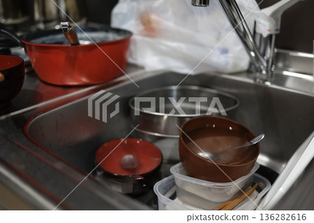 A kitchen sink filled with dishes gives off a sense of everyday life. A kitchen sink filled with dishes gives off a sense of everyday life. 136282616