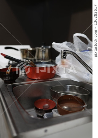 A kitchen sink filled with dishes gives off a sense of everyday life. A kitchen sink filled with dishes gives off a sense of everyday life. 136282617