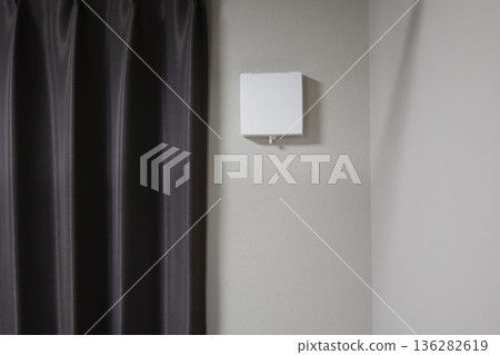 A close-up of a wall-mounted indoor ventilation fan. 136282619