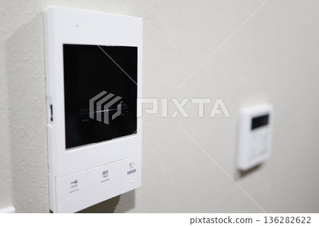 A close-up of the video door phone control panel installed on the wall. A close-up of the video door phone control panel installed on the wall. 136282622