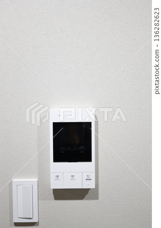 A close-up of the video door phone control panel installed on the wall. A close-up of the video door phone control panel installed on the wall. 136282623