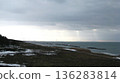 Snow-covered coastline and the Sea of Japan bathed in winter sunlight 136283814