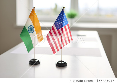 India and USA miniature desk flags ready for bilateral talks on a meeting table 136283957