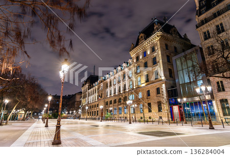 Place Louis Lepine square features historic lamp posts and the illuminated facade of the Prefecture of Police building on Ile de la Cite in Paris, France Place Louis Lepine square features historic lamp posts and the illuminated facade of the Prefecture of Police building on Ile de la Cite in Paris, France 136284004