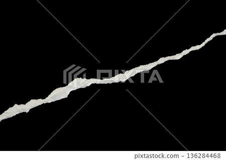Ripped torn paper edges isolated on black background Ripped torn paper edges isolated on black background 136284468